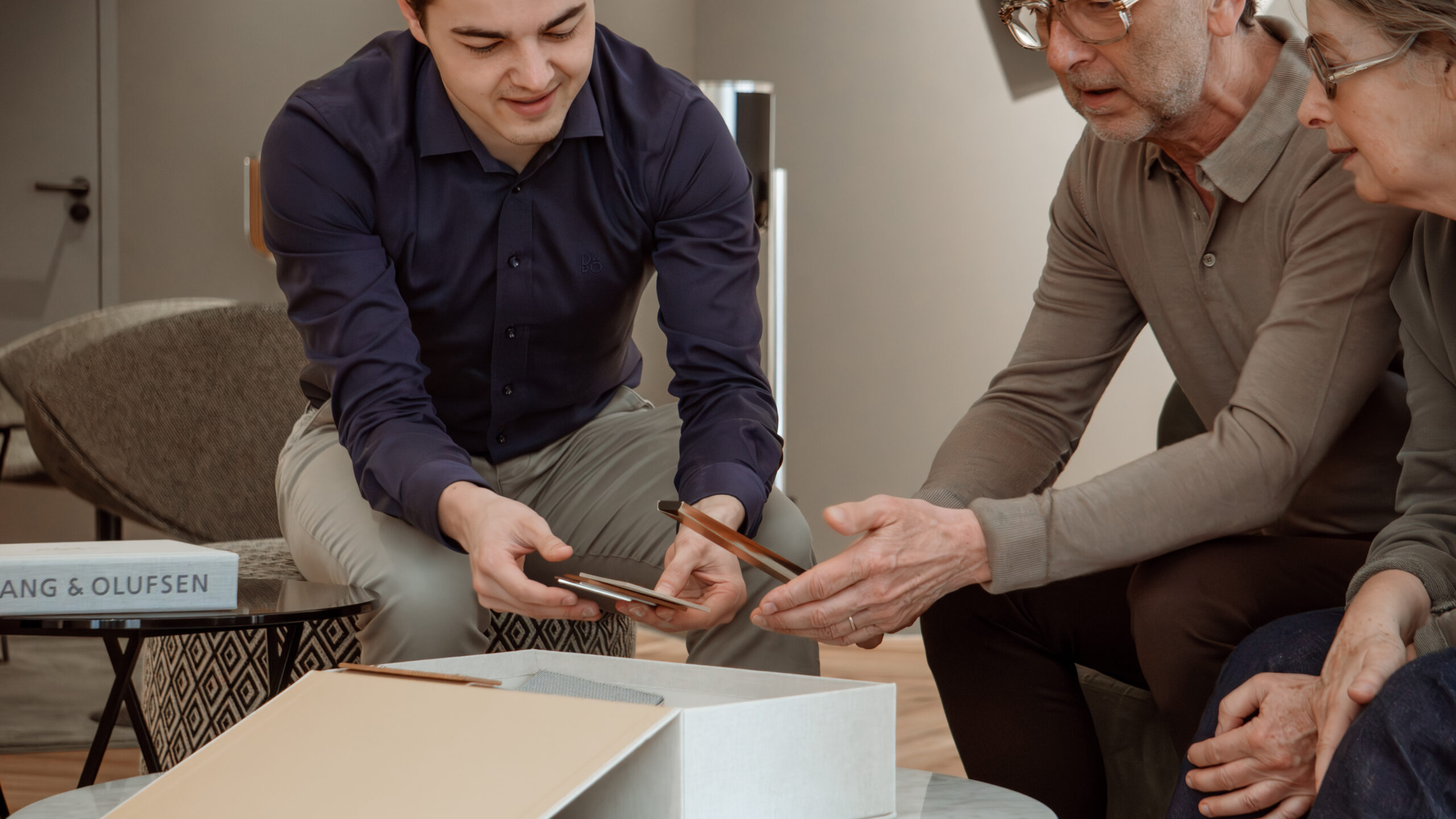 Adviseur laat materiaalstalen zien aan klanten in de showroom.