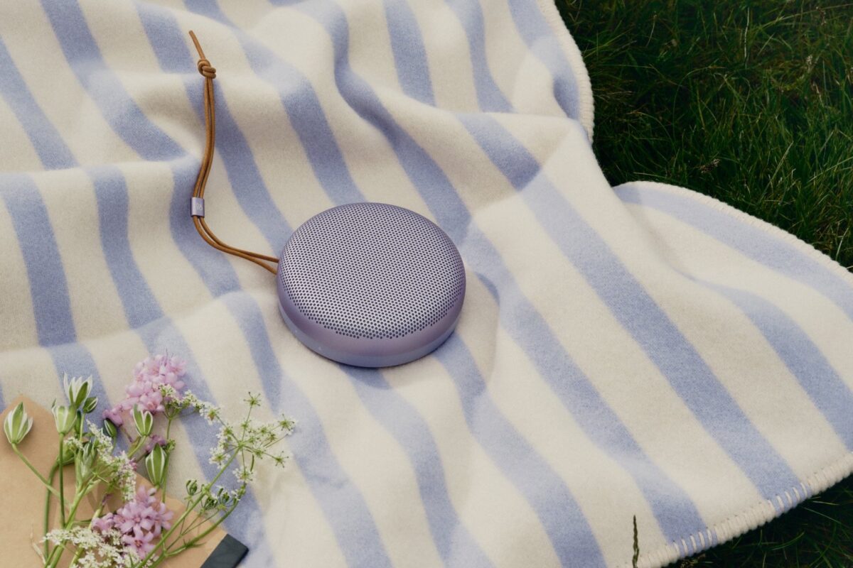 Beosound A1 3rd Gen in Lavender Purple op een gestreepte deken in het gras